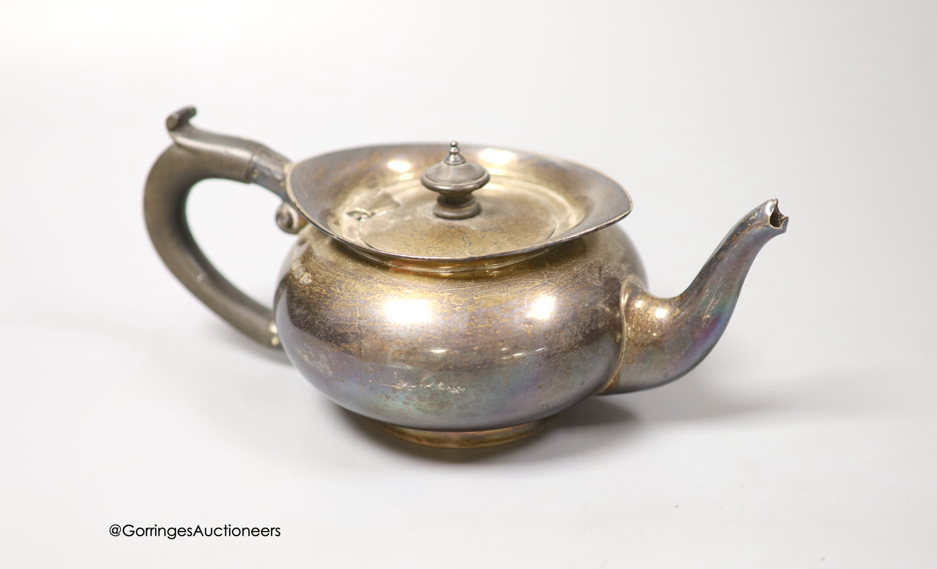 An Edwardian silver bachelor's squat circular teapot, T. Wooley, Birmingham, 1909, gross 9.5oz.